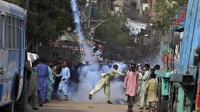 Bentrokan antara simpatisan Tehrik-e-Labaik Pakistan (TLP) dan polisi terjadi di Karachi, Pakistan, Senin (19/4/2021) waktu setempat. Dalam bentrokan itu sejumlah massa tampak melemparkan kembali tabung gas air mata yang ditembakkan polisi. AP Photo/Fareed Khan.