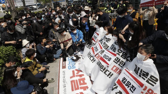 South Korean university students have their hairs shaved during a protest to denounce a decision by the Japanese government in front of a building which houses Japanese Embassy in Seoul, South Korea, Tuesday, April 20, 2021. Japan's government announced on April 13, it would start releasing treated radioactive water from the wrecked Fukushima nuclear plant into the Pacific Ocean in two years. It's a move that's fiercely opposed by fishermen, residents and Japan's neighbors. Banners mean 