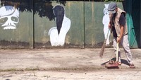 Relawan satgas jogo tonggo Desa Sepat, Kecamatan Masaran Sragen, membersihkan rumah hantu lokasi karantina pemudik membandel, Jumat (24/4/2021). 