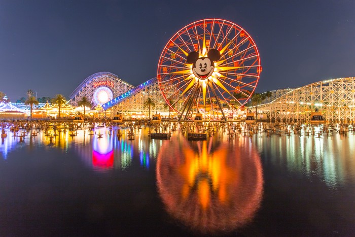 Anaheim, CA USA - August 22, 2015: Disneyland 60th aniversary at Cars Land. This year Disneyland celebrates its 60th aniversary of been open. On this day the park celebrated with fireworks and over 150 thousand people. People walk around rides and games at the downtown Cars Land during the night time..