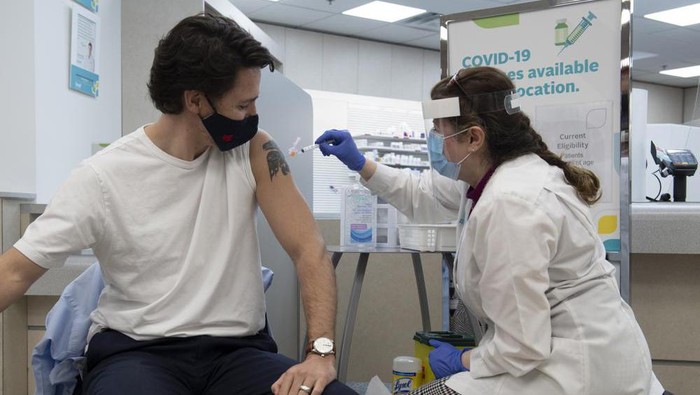 Prime Minister Justin Trudeau receives his first COVID vaccination in Ottawa, Friday April 23, 2021. (Adrian Wyld/The Canadian Press via AP)