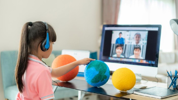 Asian girl student live learning video conference with teacher and other classmates giving presentation, showing solar model project, Homeschooling and distance learning ,online ,education and internet.
