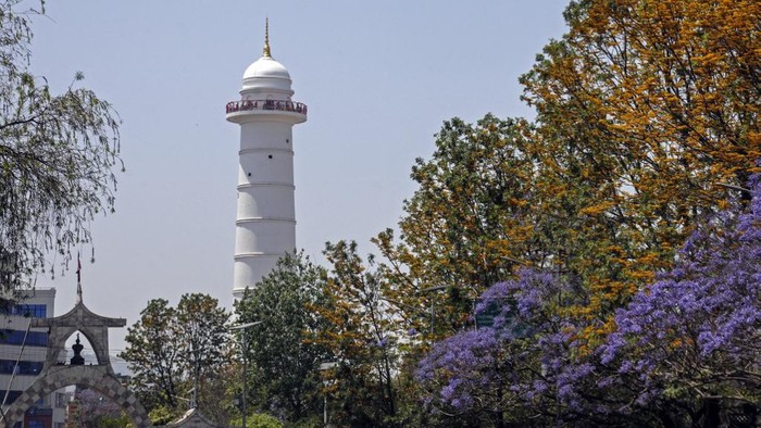 The new 23-storey, 84-metre (276-foot) white tower, built next to the rubble of the 19th-century historic Dharahara tower that collapsed in a devastating 2015 earthquake, is pictured during its inauguration ceremony in Kathmandu on April 24, 2021. (Photo by Bikash KARKI / AFP)
