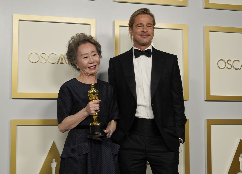 Pemain Minari di Oscar Brad Pitt, right, poses with Yuh-Jung Youn, winner of the award for best actress in a supporting role for