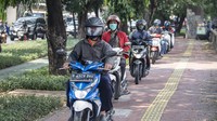 Pengendara sepeda motor melintas di atas trotoar kawasan Daan Mogot, Jakarta Barat, Senin (26/4/2021).   