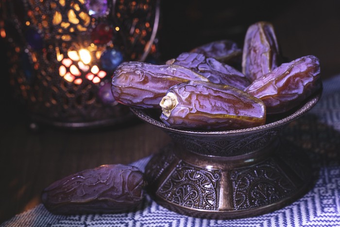 Ramadan concept with dried dates and lantern.