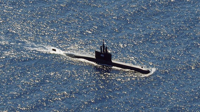 In this aerial photo taken from a maritime patrol aircraft of 800 Air Squadron of the 2nd Air Wing of Naval Aviation Center (PUSPENERBAL), the Indonesian Navy submarine KRI Alugoro sails during a search for KRI Nanggala, another submarine that went missing while participating in a training exercise on Wednesday, in the waters off Bali Island, Indonesia, Thursday, April 22, 2021. Indonesia's navy ships on Thursday were intensely searching for the submarine that likely fell too deep to retrieve, making survival chances for all the crew on board slim. Authorities said oxygen in the submarine would run out by early Saturday. (AP Photo/Eric Ireng)
