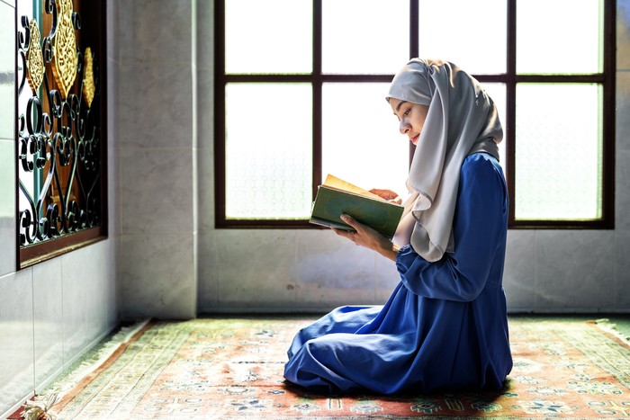 Muslim woman reading from the quran