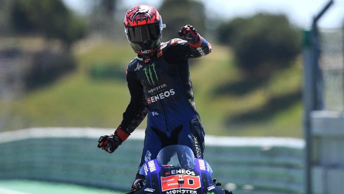 Monster Energy Yamaha MotoGPs French rider Fabio Quartararo celebrates after winning the MotoGP race of the Portuguese Grand Prix at the Algarve International Circuit in Portimao on April 18, 2021. (Photo by PATRICIA DE MELO MOREIRA / AFP)