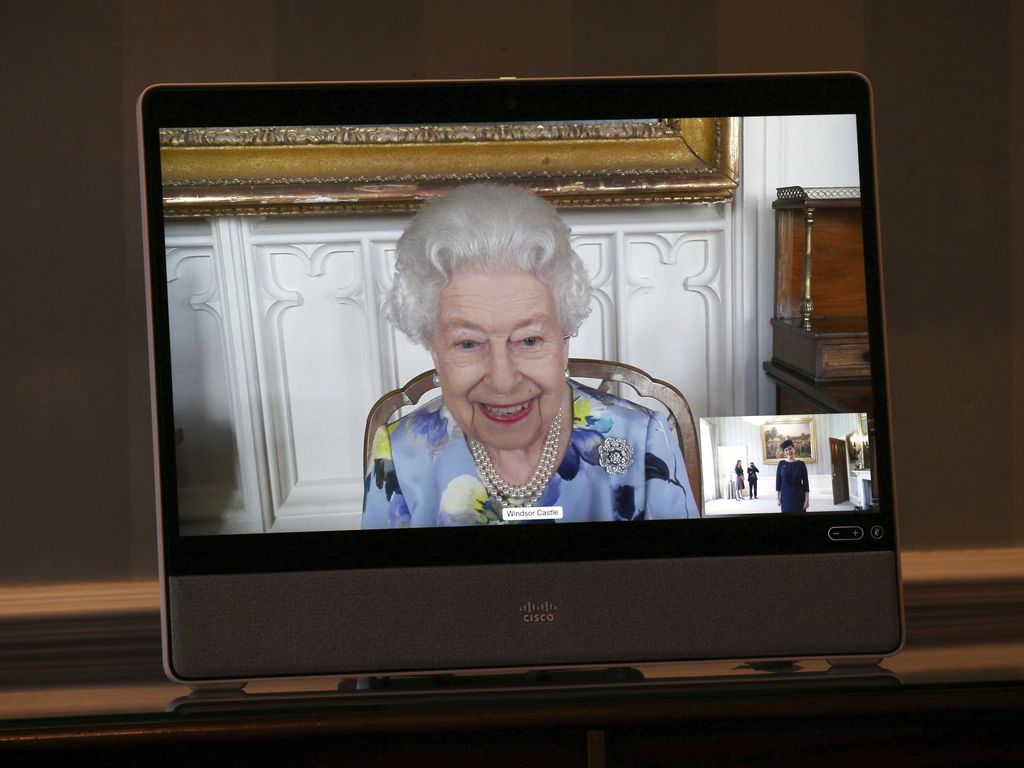Britain's Queen Elizabeth II appears on a screen by videolink from Windsor Castle, where she is in residence, during a virtual audience to receive Her Excellency Ivita Burmistre, the Ambassador of Latvia, at Buckingham Palace, London, Tuesday April 27, 2021. (Yui Mok/Pool via AP)