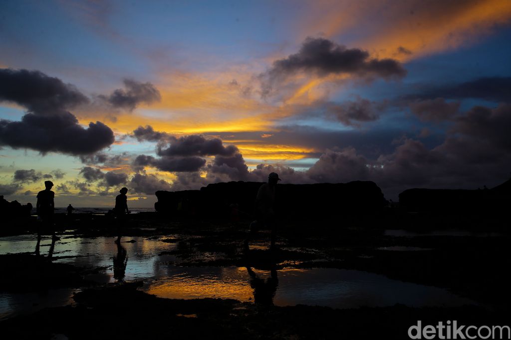 Sejumlah wisatawan menikmati pemandangan matahari terbenam di Pantai Batu Bolong, Canggu, Bali. Kawasan canggu merupakan salah satu tempat yang diincar wisatawan untuk menikmati matahari terbenam atau sunset.