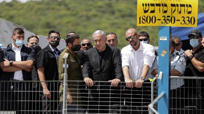 Israeli Prime Minister Benjamin Netanyahu (C) visits the site of an overnight stampede during an ultra-Orthodox religious gathering in the northern Israeli town of Meron, on April 30, 2021. - The massive stampede at the densely-packed site near the reputed tomb of Rabbi Shimon Bar Yochai, a second-century Talmudic sage, where mainly ultra-Orthodox Jews flock to mark the Lag BaOmer holiday, killed at least 44 people in northern Israel, blackening the countrys largest COVID-era gathering. (Photo by Ronen ZVULUN / POOL / AFP)