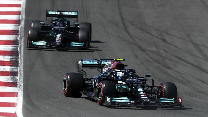 Mercedes driver Valtteri Bottas of Finland takes a curve ahead of Mercedes driver Lewis Hamilton of Britain, left, during the qualifying session ahead of the Portugal Formula One Grand Prix at the Algarve International Circuit near Portimao, Portugal, Saturday, May 1, 2021. The Portugal Grand Prix will be held on Sunday. (AP Photo/Manu Fernandez)