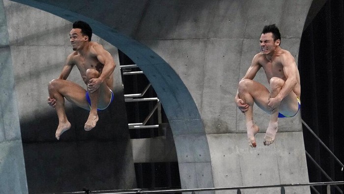 United States' Michael Hixon and Andrew Capobianco perform a dive in the men's synchronized 3-meter springboard finals at the FINA Diving World Cup Sunday, May 2, 2021, at the Tokyo Aquatics Centre in Tokyo. (AP Photo/Eugene Hoshiko)