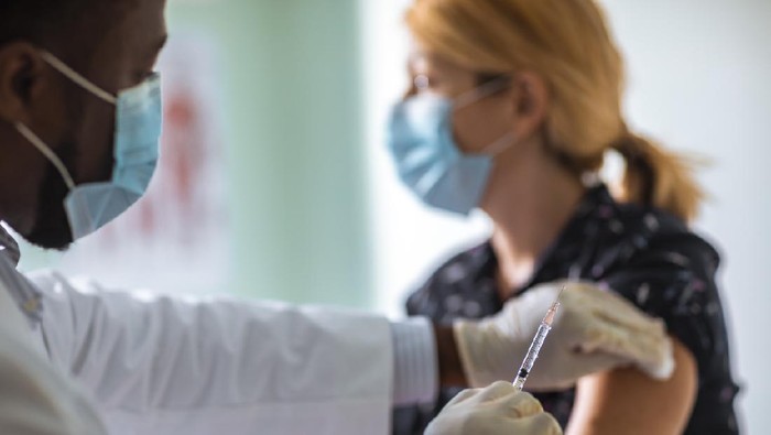 Close up of a young woman getting vaccinated