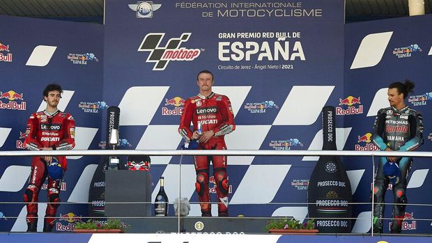 Winners on the podium, with left to right, Italian rider Francesco Bagnaia, winner Australian Jack Miller and Italian rider Franco Morbidelli after after the MotoGP Spanish Motorcycle Grand Prix at the Angel Nieto racetrack in Jerez de la Frontera, Spain, Sunday, May 2, 2021. (AP Photo/Jose Breton)