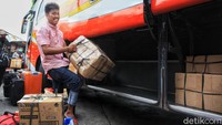 Awak bus tengah menata barang bawaan pemudik.