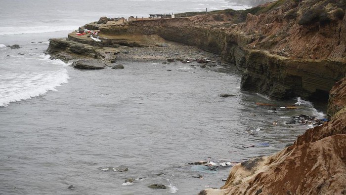 Wreckage and debris from a capsized boat washes ashore at Cabrillo National Monument near where a boat capsized just off the San Diego coast Sunday, May 2, 2021, in San Diego. Authorities say two people were killed and nearly two dozen others were hospitalized after the boat capsized. (AP Photo/Denis Poroy)