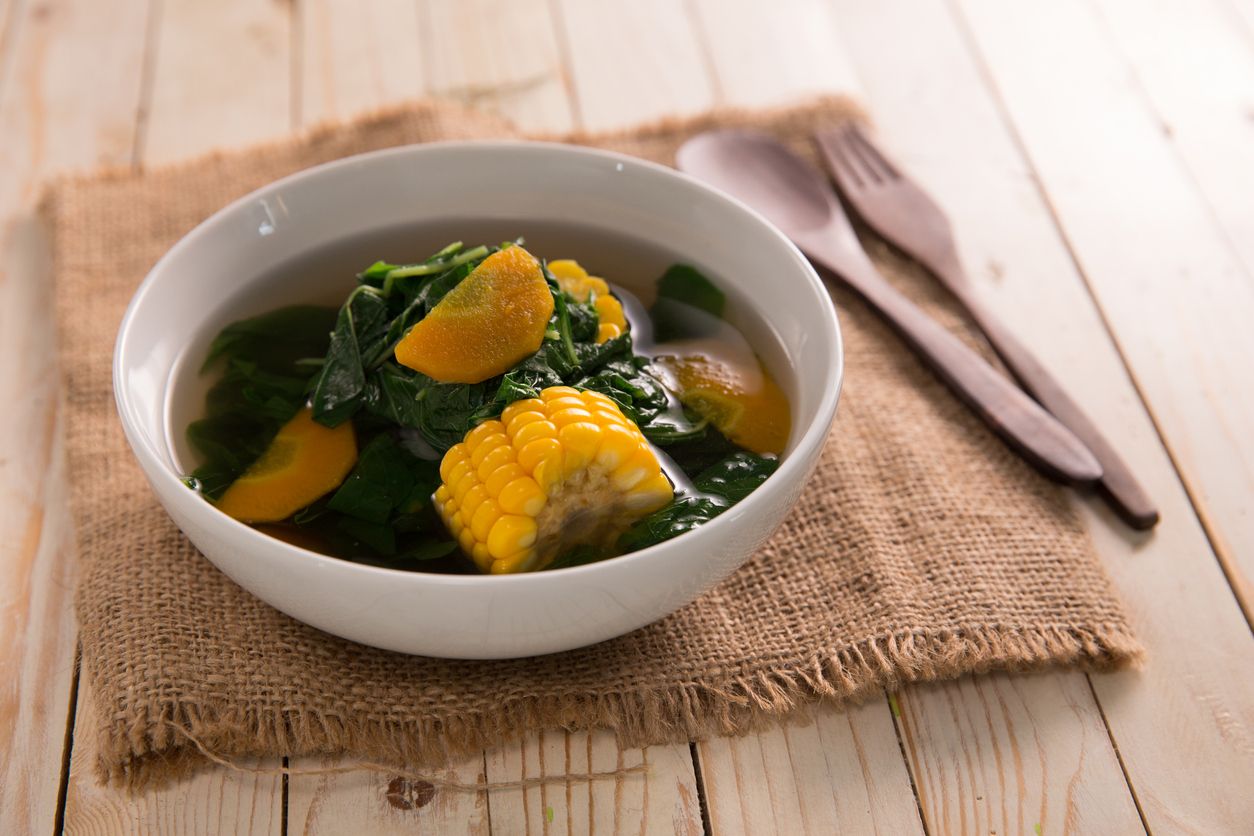 sayur bening bayam. indonesian food of spinach with soup and corn