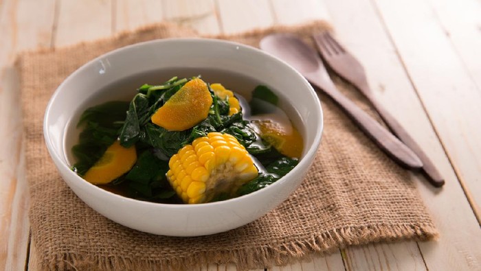 sayur bening bayam. indonesian food of spinach with soup and corn