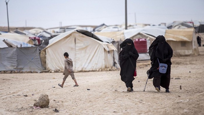 Women and children gather in front their tents at al-Hol camp that houses some 60,000 refugees, including families and supporters of the Islamic State group, many of them foreign nationals, in Hasakeh province, Syria, Saturday, May 1, 2021. Kurdish officials say security has improved at the sprawling camp in northeast Syria, but concerns are growing of a coronavirus outbreak in the facility. (AP Photo/Baderkhan Ahmad)