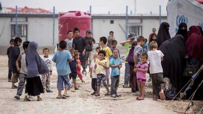 Women and children gather in front their tents at al-Hol camp that houses some 60,000 refugees, including families and supporters of the Islamic State group, many of them foreign nationals, in Hasakeh province, Syria, Saturday, May 1, 2021. Kurdish officials say security has improved at the sprawling camp in northeast Syria, but concerns are growing of a coronavirus outbreak in the facility. (AP Photo/Baderkhan Ahmad)