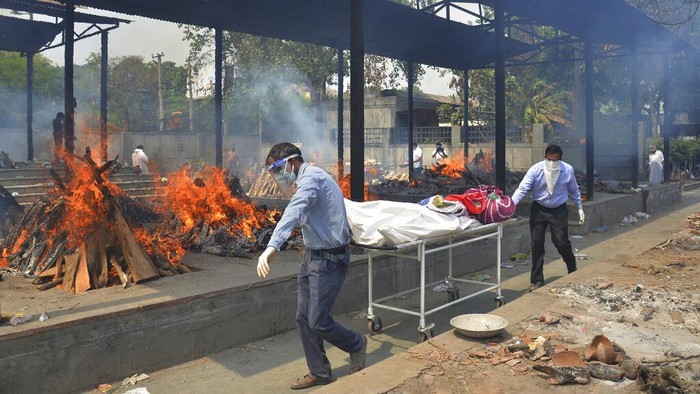 Virus Outbreak FILE - In this April 30, 2021, file photo, health workers attend to COVID-19 patients at a makeshift hospital in New Delhi, India. COVID-19 infections and deaths are mounting with alarming speed in India with no end in sight to the crisis. People are dying because of shortages of bottled oxygen and hospital beds or because they couldn’t get a COVID-19 test. (AP Photo/File)