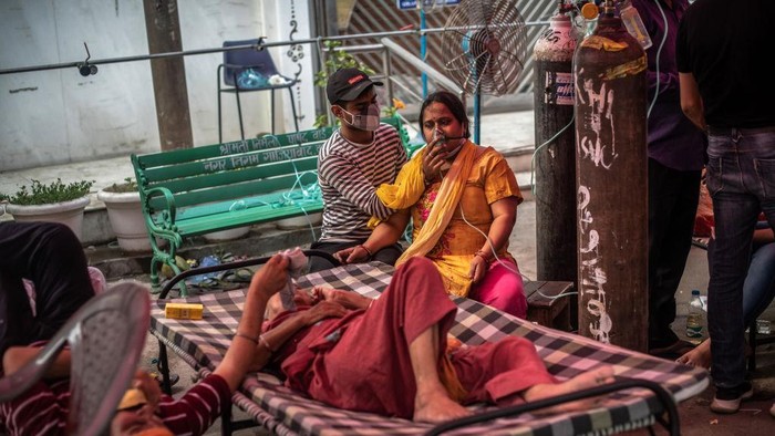 Virus Outbreak FILE - In this April 30, 2021, file photo, health workers attend to COVID-19 patients at a makeshift hospital in New Delhi, India. COVID-19 infections and deaths are mounting with alarming speed in India with no end in sight to the crisis. People are dying because of shortages of bottled oxygen and hospital beds or because they couldn’t get a COVID-19 test. (AP Photo/File)