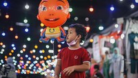 Seorang anak memegang balon di bazar Ramadhan di Kuala Lumpur, Malaysia.  