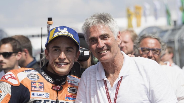 HOHENSTEIN-ERNSTTHAL, GERMANY - JULY 15:Marc Marquez of Spain and Repsol Honda Team celebrates with Michael Doohan of Australia (R) under the podium at the end of the MotoGP race during the MotoGp of Germany - Race at Sachsenring Circuit on July 15, 2018 in Hohenstein-Ernstthal, Germany.(Photo by Mirco Lazzari gp/Getty Images)