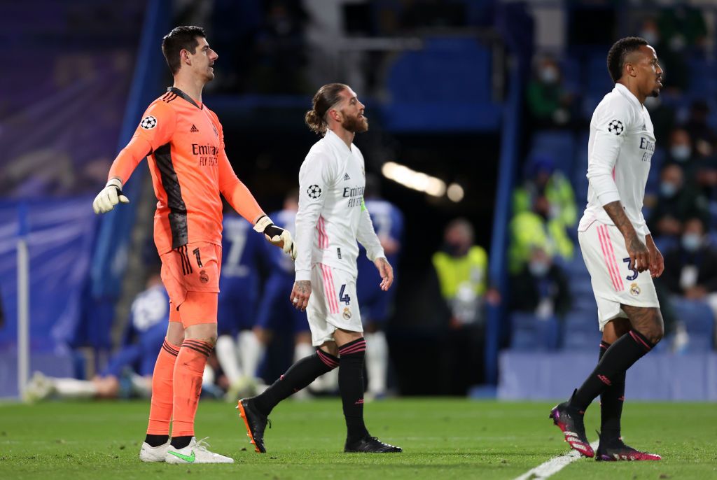 LONDON, ENGLAND - MAY 05: (L-R) Thibaut Courtois, Sergio Ramos and Eder Militao of Real Madrid look dejected after conceding a second goal during the UEFA Champions League Semi Final Second Leg match between Chelsea and Real Madrid at Stamford Bridge on May 05, 2021 in London, England. Sporting stadiums around Europe remain under strict restrictions due to the Coronavirus Pandemic as Government social distancing laws prohibit fans inside venues resulting in games being played behind closed doors. (Photo by Clive Rose/Getty Images)