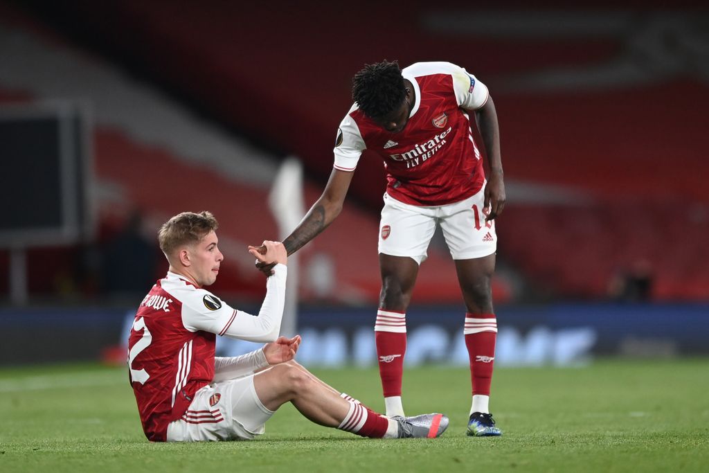 LONDON, ENGLAND - MAY 06: Emile Smith Rowe (L) of Arsenal is helped up by team mate Thomas Partey as they both look dejected following the UEFA Europa League Semi-final Second Leg match between Arsenal and Villareal CF at Emirates Stadium on May 06, 2021 in London, England. Sporting stadiums around Europe remain under strict restrictions due to the Coronavirus Pandemic as Government social distancing laws prohibit fans inside venues resulting in games being played behind closed doors. (Photo by Shaun Botterill/Getty Images)