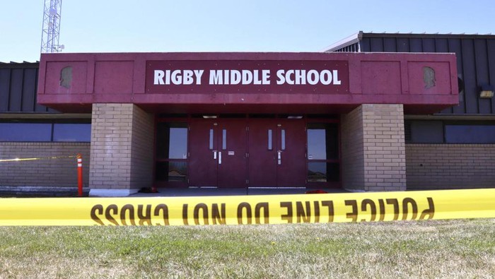 Police tape marks a line outside Rigby Middle School following a shooting there earlier Thursday, May 6, 2021, in Rigby, Idaho. Authorities said that two students and a custodian were injured, and a male student has been taken into custody. (AP Photo/Natalie Behring)