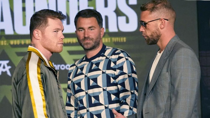 Canelo Alvarez of Mexico, left, turns away as Billy Joe Saunders of Great Britain, right, offers to shake hands as boxing promoter Eddie Hearn looks on during a pre-fight news conference, Thursday, May 6, 2021, in Arlington, Texas. Alvarez and Saunders fight on Saturday, May 8, 2021, for the unified super middleweight world championship. (AP Photo/LM Otero)
