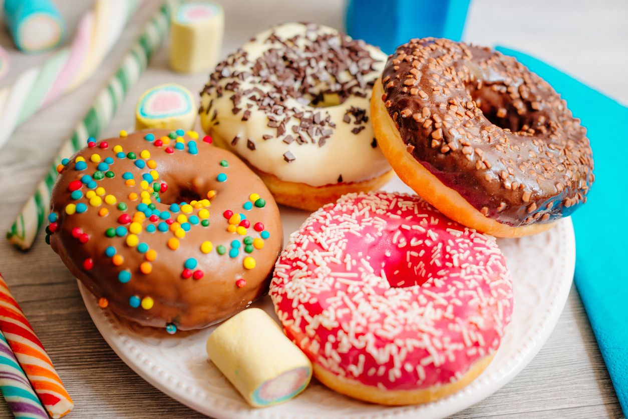 Image of multi colour glazed donuts