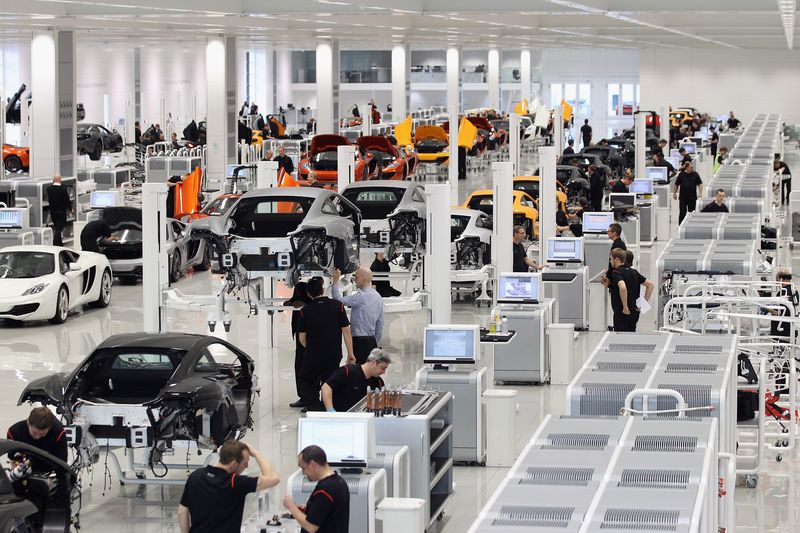 WOKING, ENGLAND - NOVEMBER 17:  Workers assemble high performance McLaren MP4-12C sports cars in the Production Centre of the McLaren Technology Centre on November 17, 2011 in Woking, England. The Surrey-based headquarters of the McLaren Group is home to a collection of campanies including McLaren Automotive and the Formaula One constructors McLaren Racing.  (Photo by Oli Scarff/Getty Images)