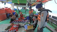Personel Polair Polres Indramayu memeriksa data Anak Buah Kapal (ABK) nelayan saat melakukan penyekatan jalur laut di perairan Indramayu, Jawa Barat.