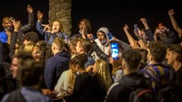 Sejumlah warga berpesta dan bersuka cita di pantai Barcelona pada Minggu (9/5/2021) dini hari.