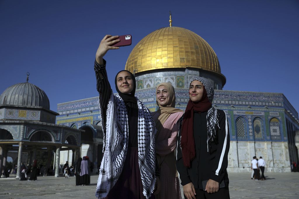 Women pose for a selfie for Eid al-Fitr at the Dome of the Rock Mosque in the Al-Aqsa Mosque compound in the Old City of Jerusalem, Thursday, May 13, 2021. Eid al-Fitr, festival of breaking of the fast, marks the end of the holy month of Ramadan. (AP Photo/Mahmoud Illean)