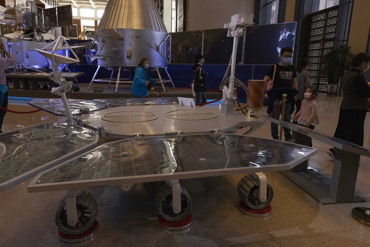 Chinese Mars Rover Landing A visitor to an exhibition on Chinas space program looks at a life size model of the Chinese Mars rover Zhurong, named after the Chinese god of fire, at the National Museum in Beijing on Thursday, May 6, 2021. China has landed a spacecraft on Mars for the first time in the latest advance for its space program. The official Xinhua News Agency said Saturday, May 15, that the lander had touched down, citing the China National Space Administration. Chinese characters read: Build a Space Power. (AP Photo/Ng Han Guan)