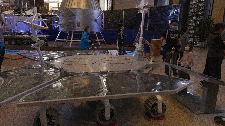 A visitor to an exhibition on Chinas space program looks at a life size model of the Chinese Mars rover Zhurong, named after the Chinese god of fire, at the National Museum in Beijing on Thursday, May 6, 2021. China has landed a spacecraft on Mars for the first time in the latest advance for its space program. The official Xinhua News Agency said Saturday, May 15, that the lander had touched down, citing the China National Space Administration. Chinese characters read: Build a Space Power. (AP Photo/Ng Han Guan)