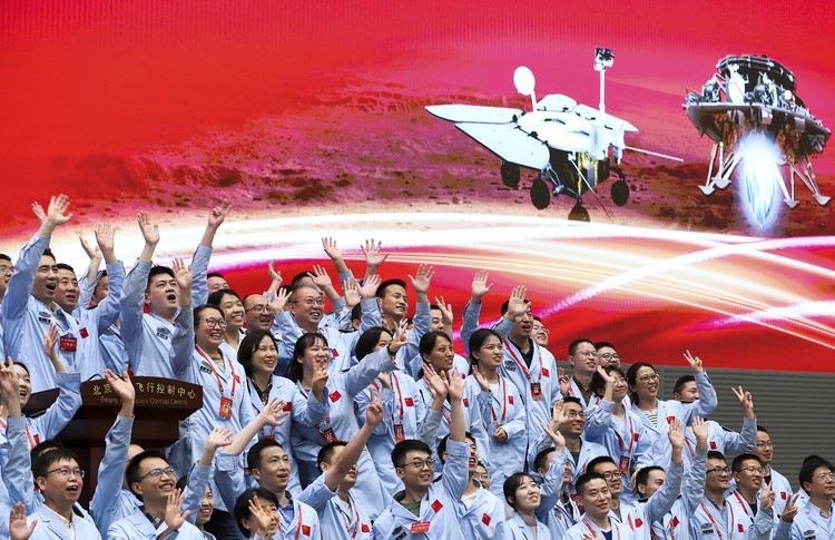 Chinese Mars Rover Landing A visitor to an exhibition on Chinas space program looks at a life size model of the Chinese Mars rover Zhurong, named after the Chinese god of fire, at the National Museum in Beijing on Thursday, May 6, 2021. China has landed a spacecraft on Mars for the first time in the latest advance for its space program. The official Xinhua News Agency said Saturday, May 15, that the lander had touched down, citing the China National Space Administration. Chinese characters read: Build a Space Power. (AP Photo/Ng Han Guan)