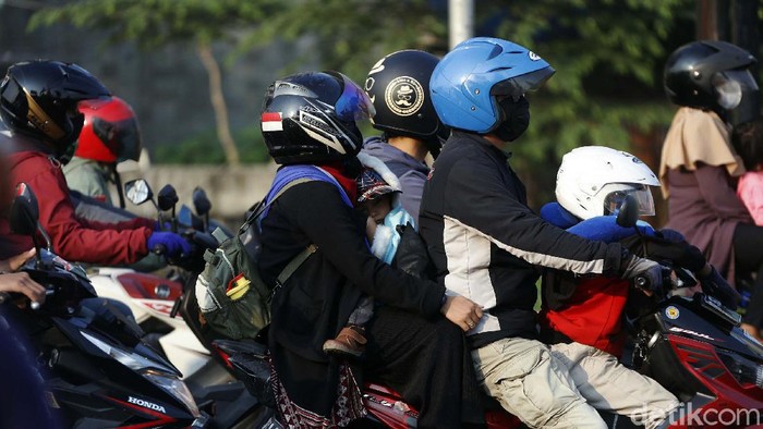Sejumlah pemudik bermotor terlintas melintasi Jalan Kalimalang Raya, Cibitung, Kabupaten Bekasi, Minggu (16/5). Banyak yang membawa anak namun tidak dilengkapi helm.