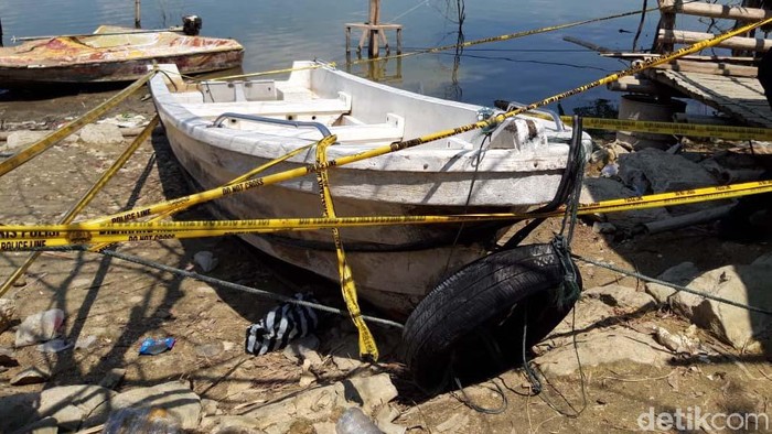 Perahu wisata pengangkut 20 orang yang terbalik di Waduk Kedungombo (WKO) Boyolali saat ini ditambatkan di pinggir waduk. Perahu itu dipasangi garis polisi.