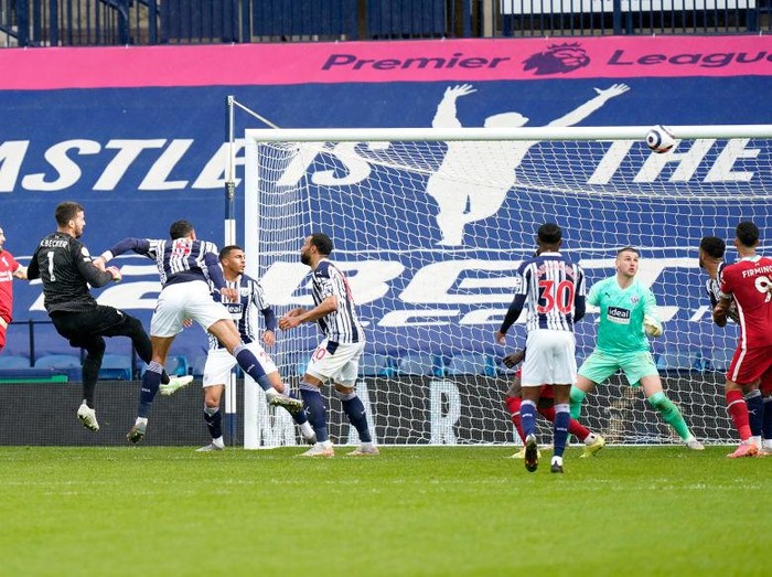 WEST BROMWICH, ENGLAND - MAY 16: Alisson of Liverpool scores their side's second goal past Sam Johnstone of West Bromwich Albion during the Premier League match between West Bromwich Albion and Liverpool at The Hawthorns on May 16, 2021 in West Bromwich, England. Sporting stadiums around the UK remain under strict restrictions due to the Coronavirus Pandemic as Government social distancing laws prohibit fans inside venues resulting in games being played behind closed doors. (Photo by Tim Keeton - Pool/Getty Images)