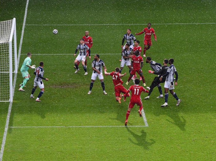 WEST BROMWICH, ENGLAND - MAY 16: Alisson Becker of Liverpool scores the winning goal past Sam Johnstone of West Bromwich Albion during the Premier League match between West Bromwich Albion and Liverpool at The Hawthorns on May 16, 2021 in West Bromwich, England. (Photo by Laurence Griffiths/Getty Images)