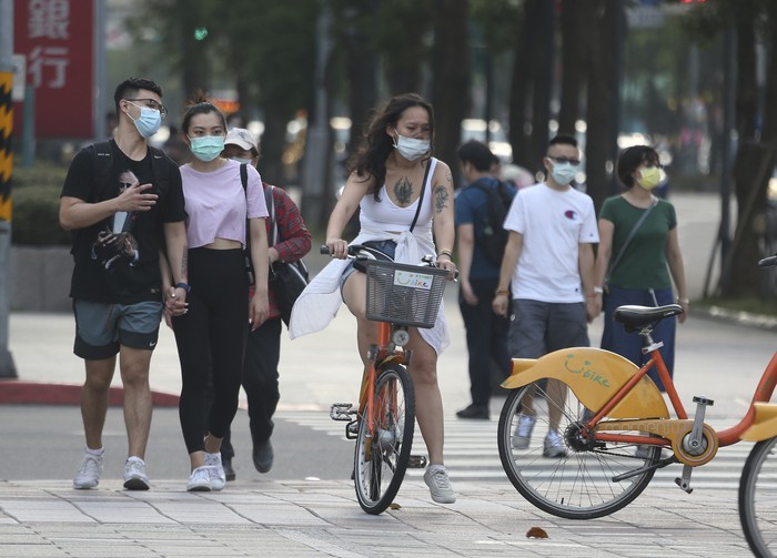 People wear face masks to protect against the spread of the coronavirus after the COVID-19 alert raise to level 3 in Taipei, Taiwan, Saturday, May 15, 2021. Taiwan, which has had enviable success in containing COVID-19, imposed new restrictions in its capital city on Saturday as it battled its worst outbreak since the pandemic began. (AP Photo/Chiang Ying-ying)