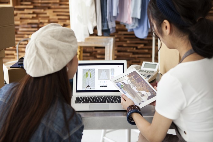 Two women selling clothes at online shopping