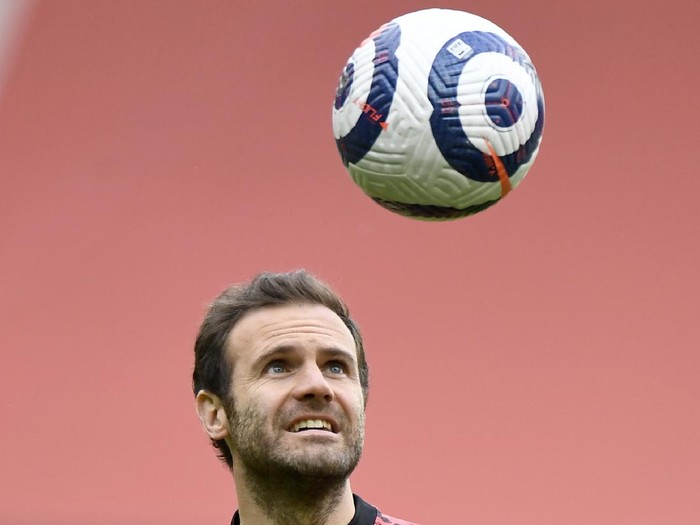 Manchester Uniteds Juan Mata heads the ball during warm up before the English Premier League soccer match between Manchester United and Leicester City, at the Old Trafford stadium in Manchester, England, Tuesday, May 11, 2021. (Peter Powell/Pool via AP)