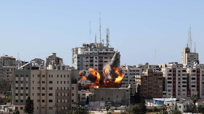 Smoke billows from a building housing various international media, including The Associated Press, after an Israeli airstrike on Saturday, May 15, 2021 in Gaza City.  The attack came roughly an hour after the Israeli military ordered people to evacuate the building, which also housed Al-Jazeera and a number of offices and apartments. There was no immediate explanation for why the building was targeted.  (Mahmud Hams /Pool Photo via AP)